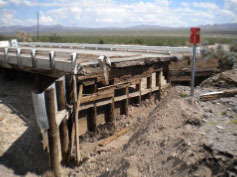 A section of road that has collapsed due to water erosion. 